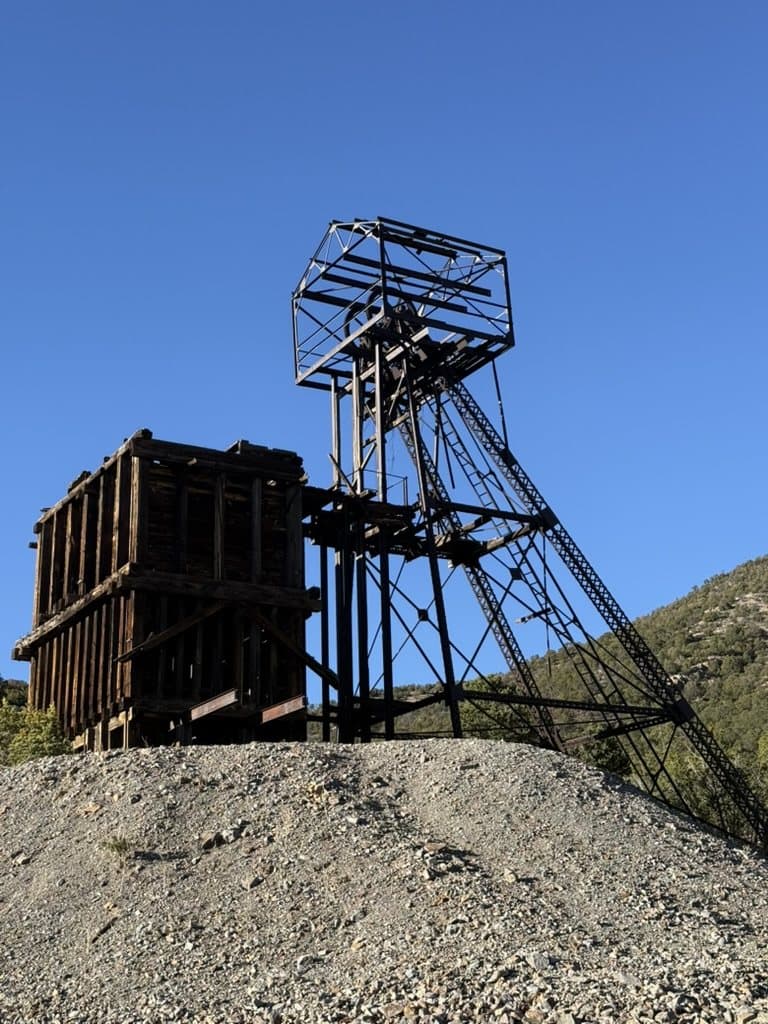 Historic mining structure under a clear blue sky