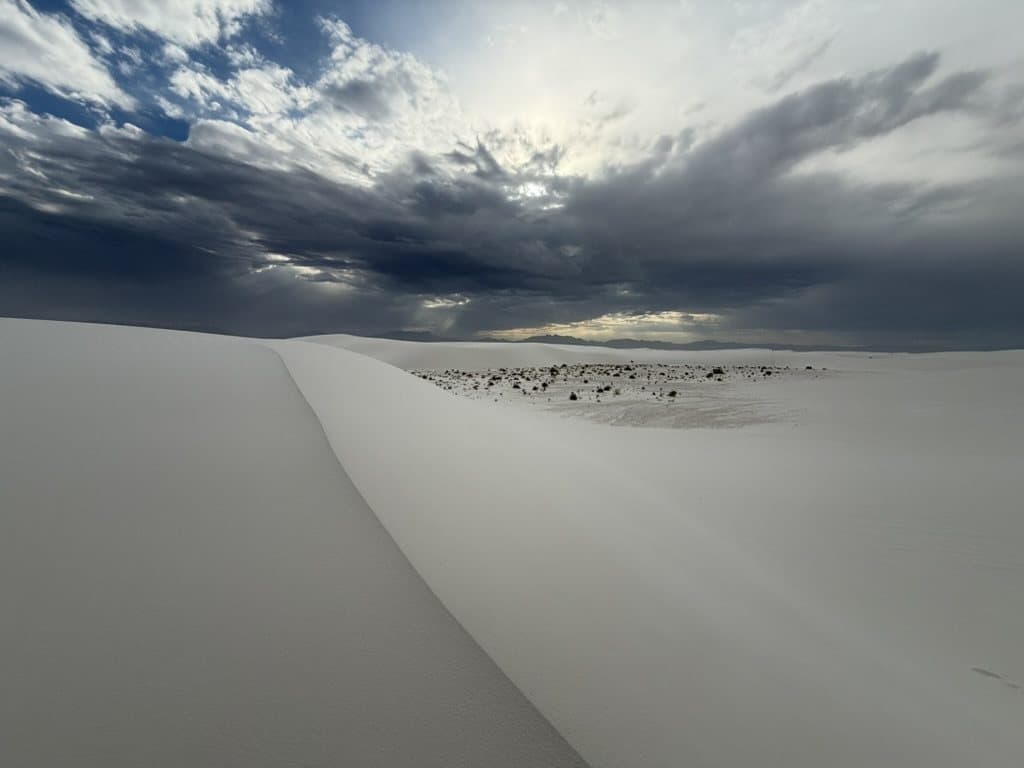 White Sands dunes beneath a dramatic storm sky