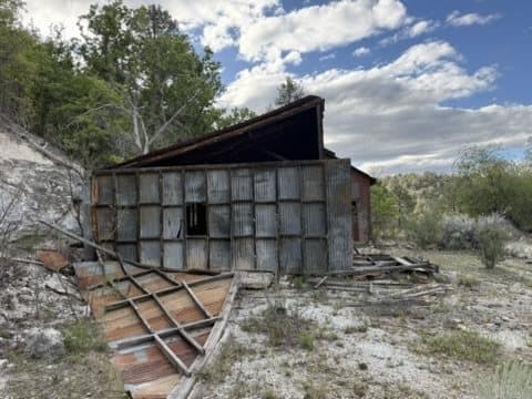 Abandoned corrugated building along an old trail